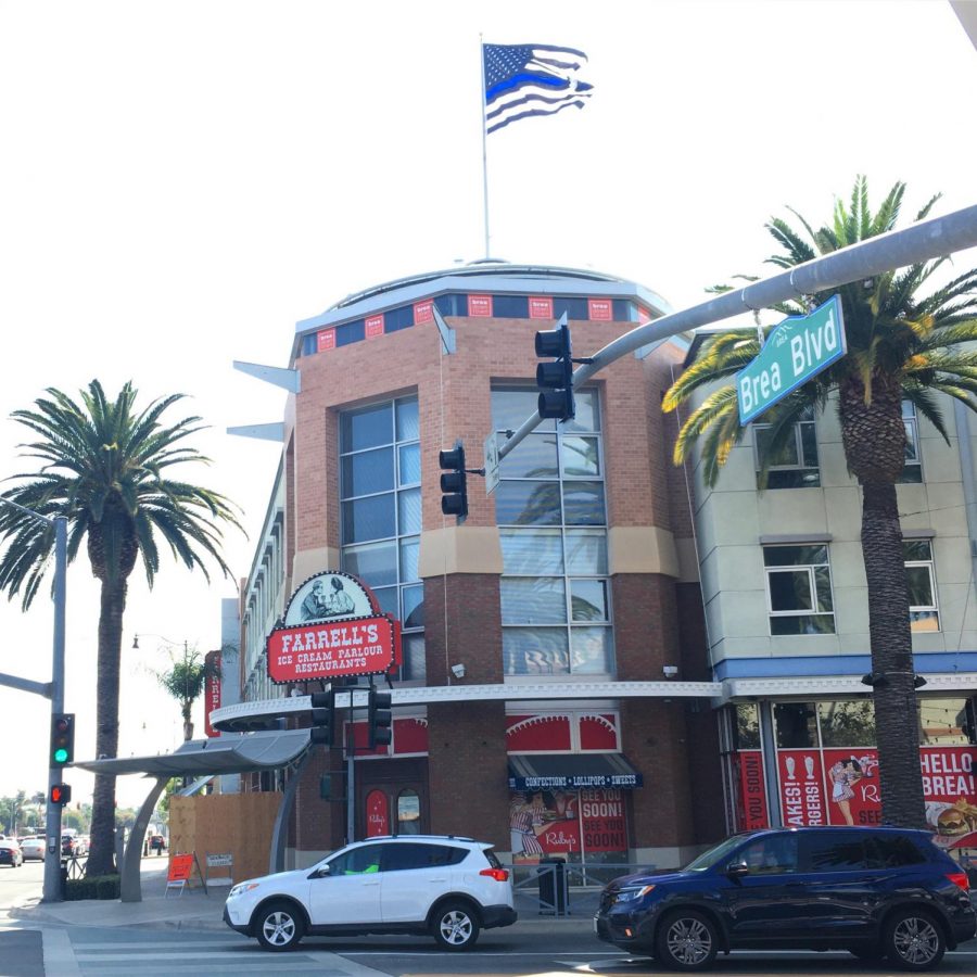 A+Thin+Blue+Line+flag+stands+atop+the+Farrells+building+in+Downtown+Brea.+The+raising+of+the+flag+stirred+debate+in+the+Brea+community.+