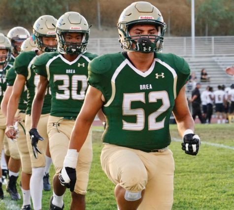 Senior Ulises Reveles leads the Wildcats in a drill prior to the start of the Sept. 20 contest against Fullerton High School. The Wildcats prevailed behind four TD's by senior Christian Steward.
