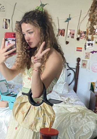 Carly Noller, senior, poses with a newly thrifted outfit. On the Depop app, Noller has created a small business that has given her the opportunity to sell thrifted and handmade items to other online thrifters like herself. 