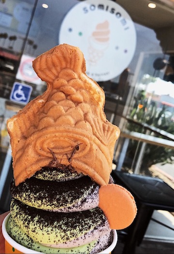 Ah-boong, a multilayered treat consisting of fish-shaped pastry stuffed with filling and topped with soft serve. Taiyakis are fish-shaped snacks best described as a blend of a waffle and a cake filled with azuki sweet red bean paste.