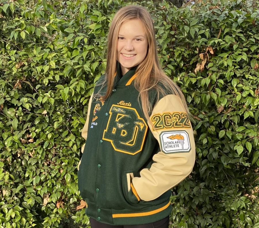 Alexis Alexander, junior, wears a patch-adorned letter jacket that she bought during quarantine  to celebrate her academic and athletic success. 