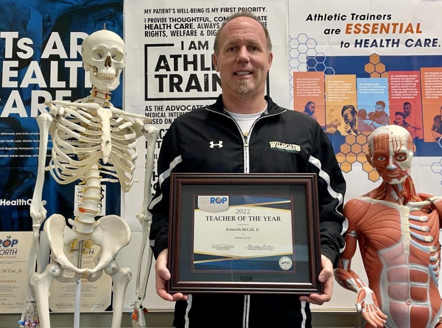 Ken McCall, athletic trainer, holds his award for North Orange County ROP Teacher of the Year. In order to be considered for this honor, teachers must be nominated by the NOCROP administration, based on demonstrating certain qualities including empowering teaching abilities, professionalism, and excellence in promoting leadership beyond the regular job obligations.