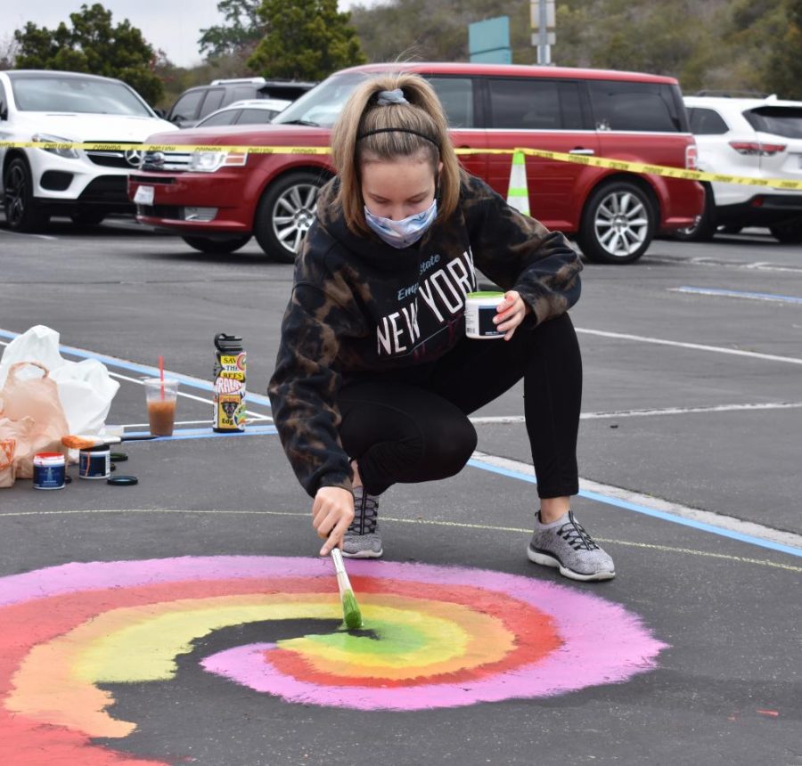 Macy Pease, senior, paints her parking spot to celebrate the last few weeks of high school. As a new BOHS tradition, seniors gathered on April 24 to paint parking spots with their desired patterns.