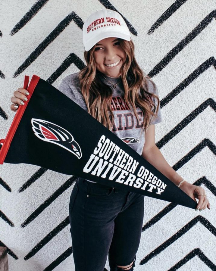 Senior+Kami+Klapp+with+a+pennant+from+Southern+Oregon+University%2C+which+she+will+attend+on+a+softball+scholarship.+