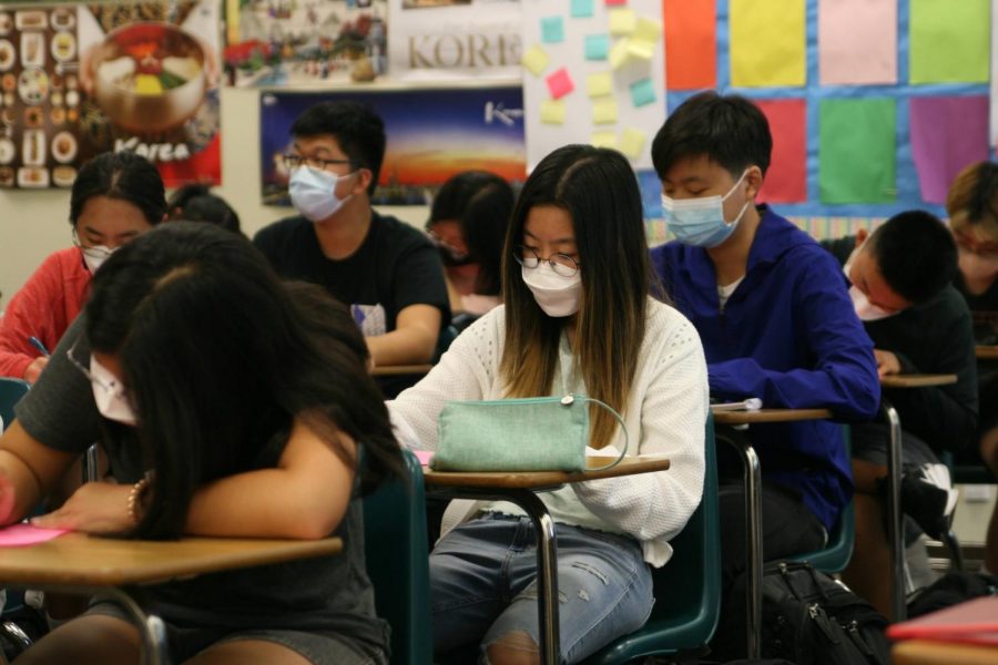 Sophomores in Sera Yoon’s Korean 2 class work on a “Get to Know Me” worksheet. Students returned to complete in-person learning on Monday while following COVID-19 safety guidelines, including mandatory mask wearing.