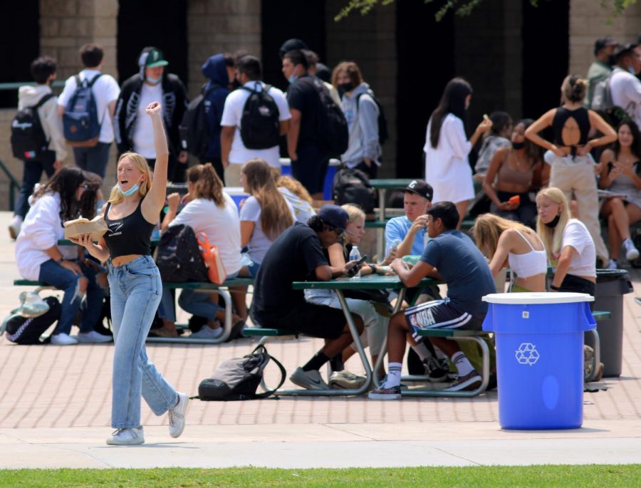 Haylee Long, sophomore, greets students from across the quad. The week of Aug. 16 to Aug. 20 marked the first time in 17 months that the entire student body had access to the quad for lunch. 
