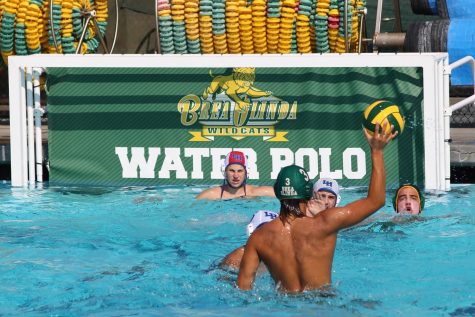 Lee Bullock, senior, attacks the La Habra High School goal at the Aug. 30 varsity contest at the BOHS pool. The Wildcats prevailed, 17-6. 
