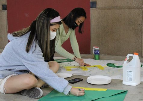 ASBs Kelly Kim and Katie Kim, seniors, make Homecoming posters to promote Fridays Hollywood-themed dance at the Yost Theatre in Santa Ana.