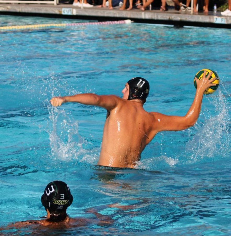 Tyler Peterson, junior, rises out of the water to take a shot on goal against Fullerton High School on Sept. 14. The Wildcats escaped with a 13-12 win. 