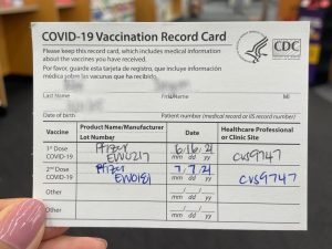 A BOHS student holds their vaccination card. California Governor Gavin Newsom announced on Oct. 1 that all public and private schools will be expected to mandate COVID-19 vaccinations on a still-to-be-determined date in 2022. 