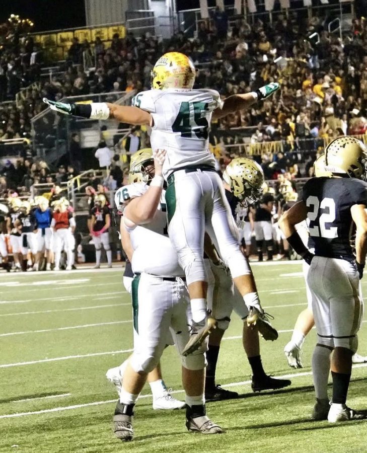 Jeff Wallace, senior, lifts senior Aidan Arnold in celebration during the Wildcats win over El Dorado High School on Oct. 29. Footballs season continues tomorrow evening against the visiting Silverado Silver Hawks in the CIF Div. 8 play-off opener. 