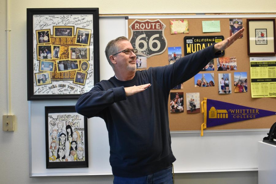 Newspaper adviser and English teacher, Rollie Ham, poses in front of his personalized board. Ham has been teaching for 28 years, and has taught at Brea Olinda High School for 17 years.