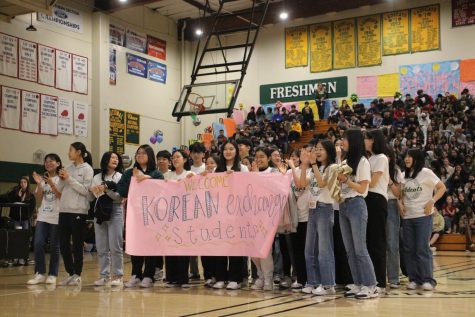 Korean Exchange students stand in the main gym during the Winter Rally and receive welcoming applause. Anseong students returned to Korea on Jan. 21 after a two-week cultural exchange experience.