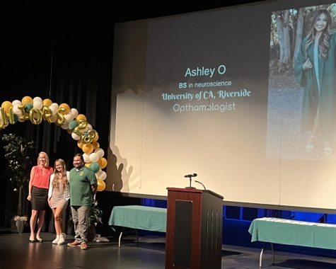 Ashley Ochoa, senior and president of AVID, is honored on the PAC stage with Amanda Louis, AVID teacher, and Fernando Grimaldo, assistant principal. Ochoa, and other seniors in the AVID program, celebrated their college commitments at the annual AVID Signing Day on April 28. 