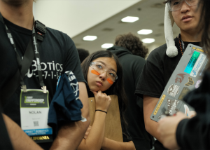 Team 7157 member Lindsey Suzuki, freshman, attends a strategy meeting at the FIRST Robotics World Championships in Houston. The team placed third in the competition, its best-ever finish at the international event. 