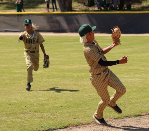 Connor Perez, sophomore, makes a catch against Linfield Christian High School as teammate Brian Shrubb, junior, races in from the outfield. 