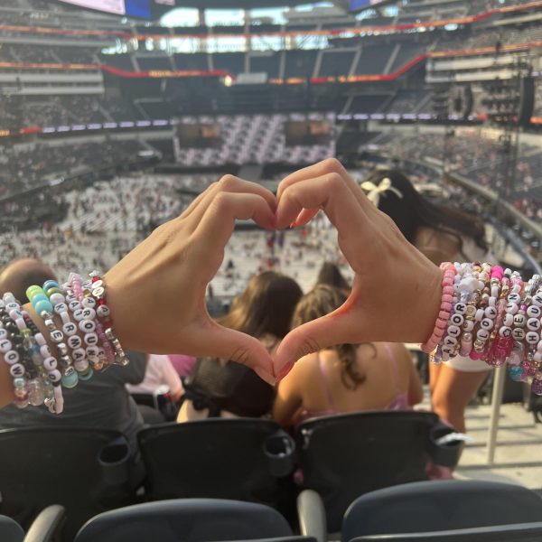Author Sofia Rodriguez and her bracelet-laden wrists at Taylor Swifts Eras Tour at SoFi Stadium in Los Angeles on August 3. The bracelets -- featuring lyrics from Swifts songs -- were collected from fellow Swift fans who exchanged the accessories before the show. 