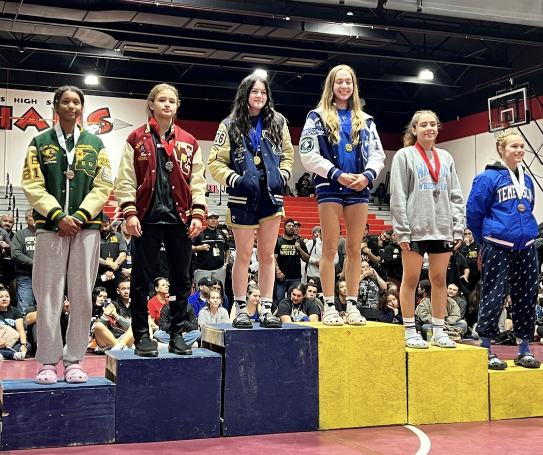 Mikayla Brent, junior, far left, stands atop the podium at the Southern Section Masters Meet at Palm Springs High School on Feb. 17. Brent won four of five matches in the 120-pound division and advanced to the 2024 CIF State Wrestling Championships in Bakersfield. (Courtesy of Mikayla Brent)