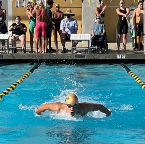 Carter Lavold swims the 100-meter butterfly in the Crestview League finals in 2021. On March 6, Lavold used the stroke to propel to an 11-second win in a 500-meter freestyle race at the Wildcat pool. 