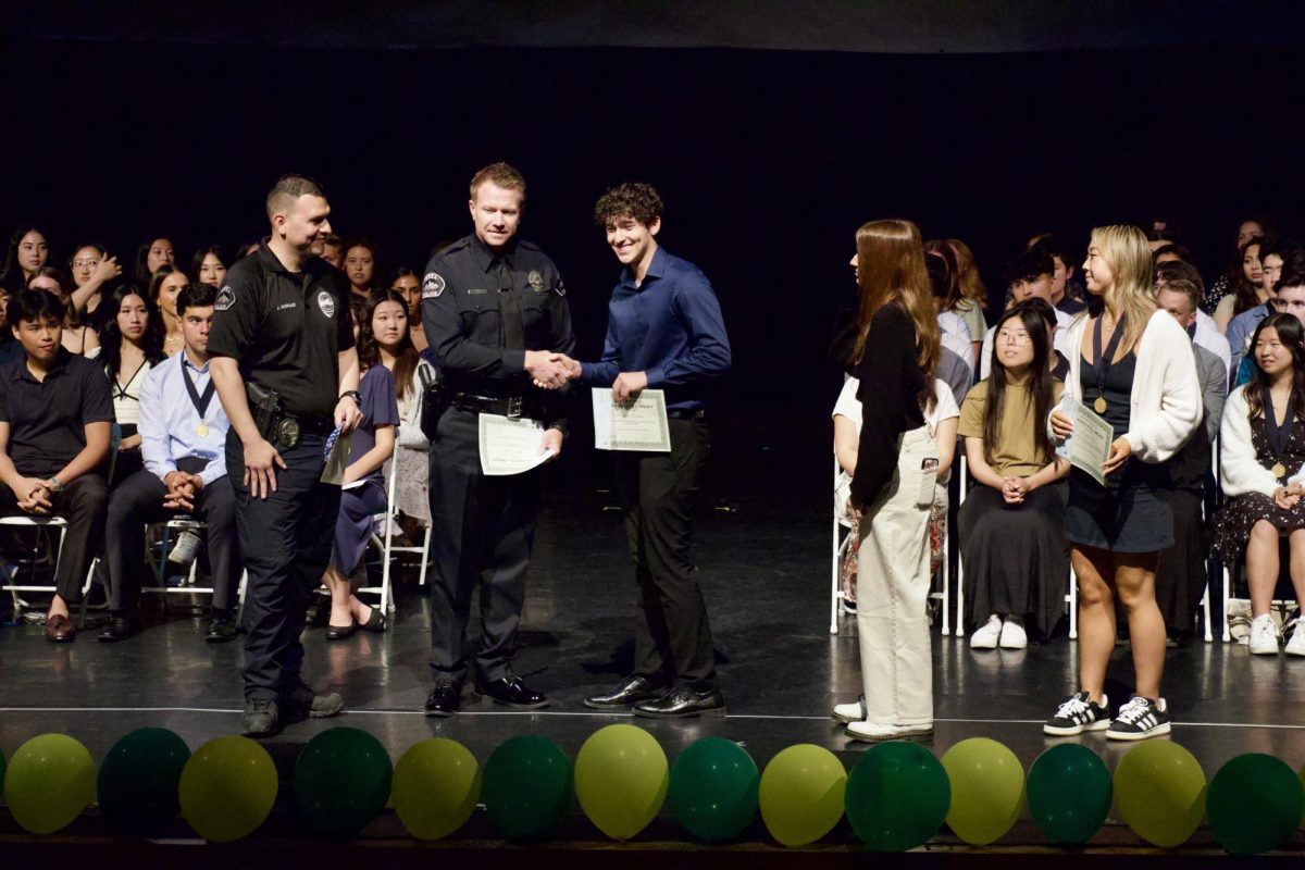 School Resource Officer Steven Wulff awards senior Darren Espinosa the Brea Police Association Scholarship. 99 seniors were awarded scholarships and recognitions at Senior Awards Night on May 21. 