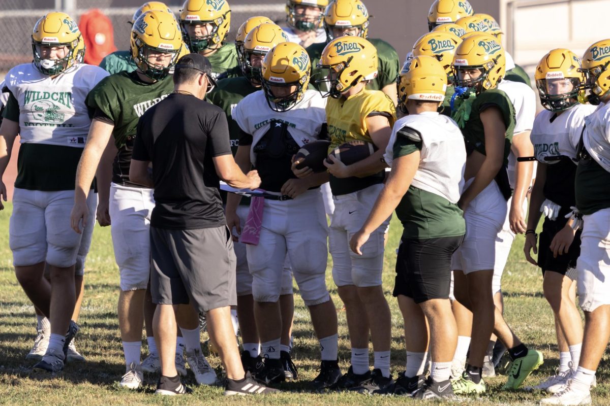 Varsity football head coach Justin Villasenor addresses his team at a pre-season practice. Although "Coach V." was hired last spring to lead the program, he's been on the Wildcat sidellnes in various roles since 2008.