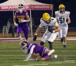 Nathan Aceves ('25) runs over, and past, a Diamond Bar defender on Sept. 6. The senior running back rushed for 122 yards and two touchdowns against the  Brahmas in the 41-18 win. 