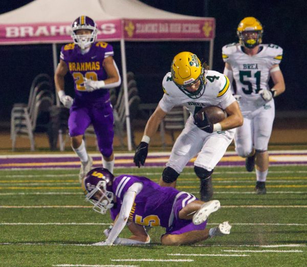 Nathan Aceves ('25) runs over, and past, a Diamond Bar defender on Sept. 6. The senior running back rushed for 122 yards and two touchdowns against the  Brahmas in the 41-18 win. 