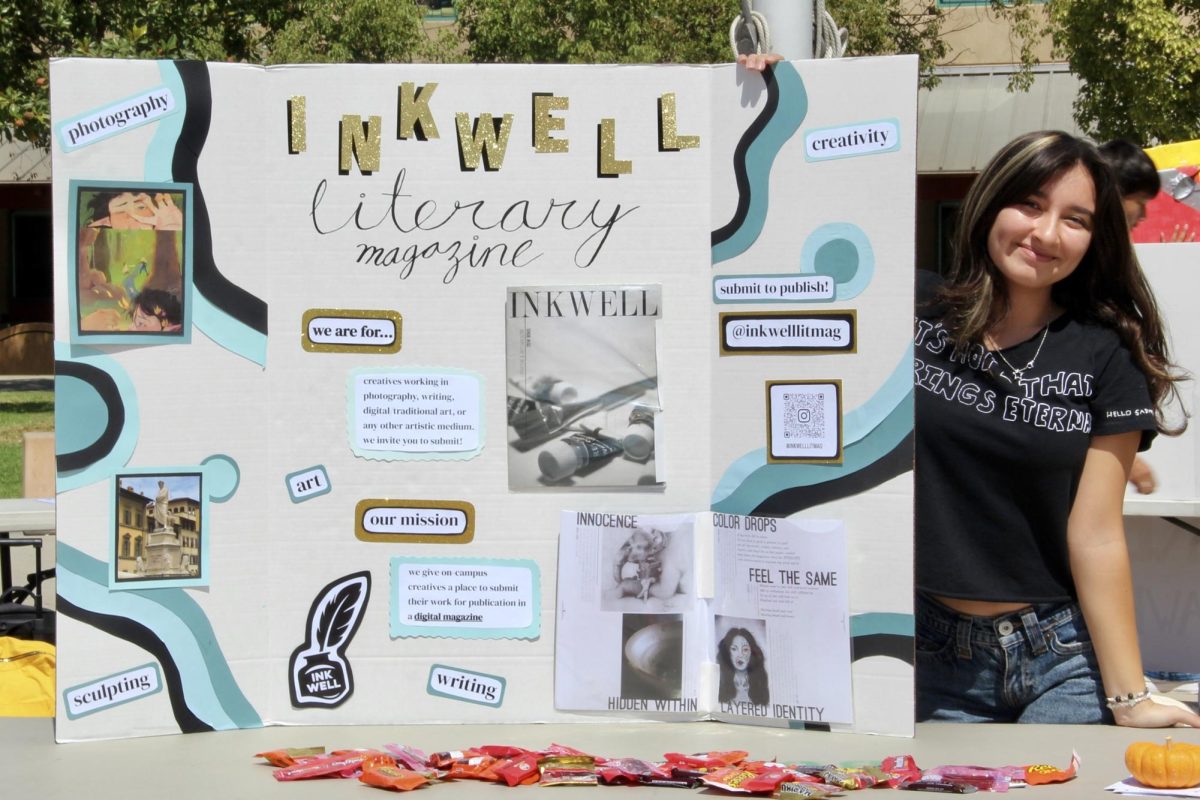 Sofia Rodriguez ('26), Inkwell Editor-in-Chief, with a display for her publication.