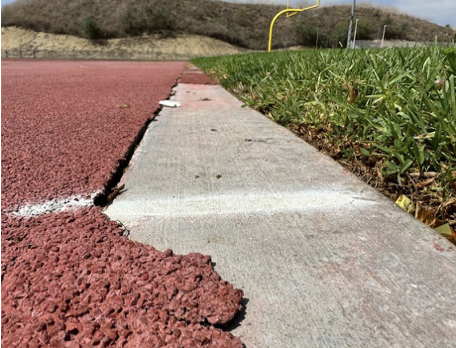 The cracked track in Wildcat Stadium. BOUSD will prioritize the resurfacing of the track and reseeding and leveling the grass field in Wildcat Stadium. (Courtesy of BOUSD.)