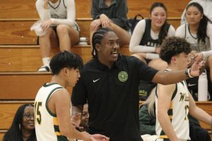 Boys' varsity head coach O'Shae Williams and point guard Tyson Tayag during the season-opener on Nov. 19 against Riverside Prep. Tayag contributed nine points, nine rebounds, and six steals in a  79-32 win over visiting Riverside Prep. (Courtesy of Haley Thomann)