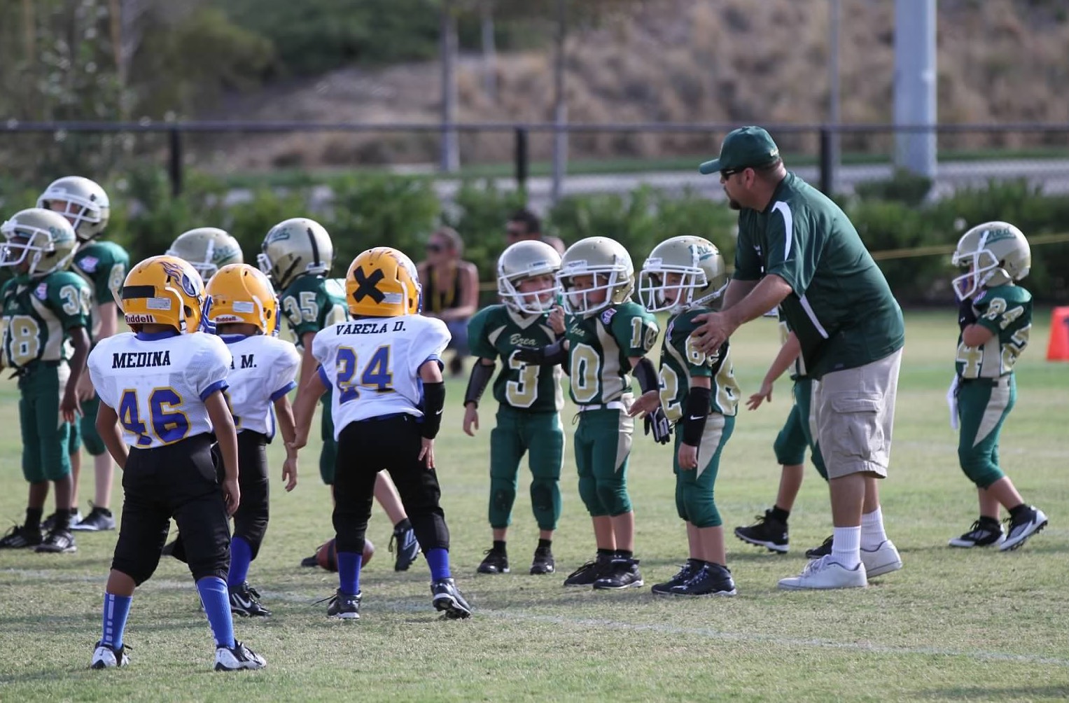 Brea Pop Warner coach Jay Luevanos ('92) and his Tiny Mites team at a 2024 practice. Luevanos also coaches the running backs for the Wildcats varsity team. (Courtesy of Kelly Mason)