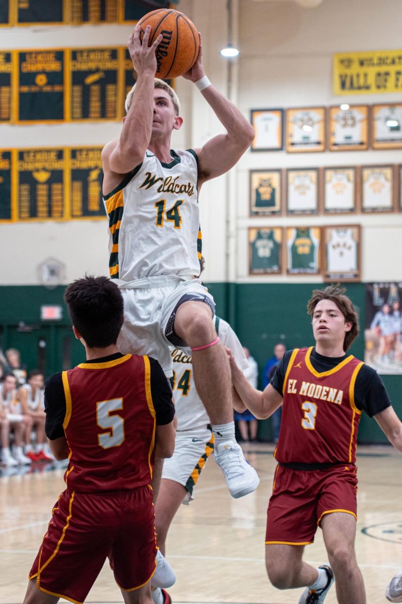 Carson Tracey ('26) elevates over an El Modena defender for two of his team-high 16 points in the Wildcats' win.