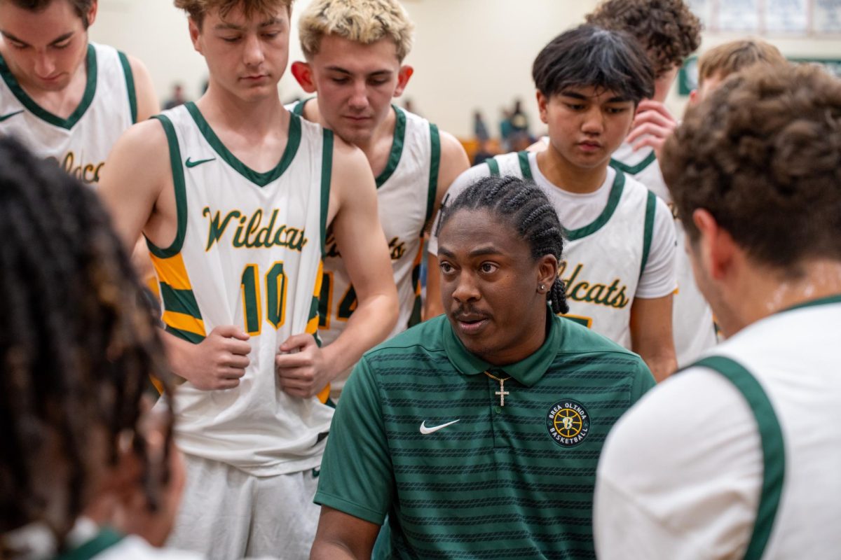 Varsity head coach O’Shae Williams talks to his team during a timeout. The first-year coach has led the program to an 11-10 overall record, and 2-1 in North Hills League. 