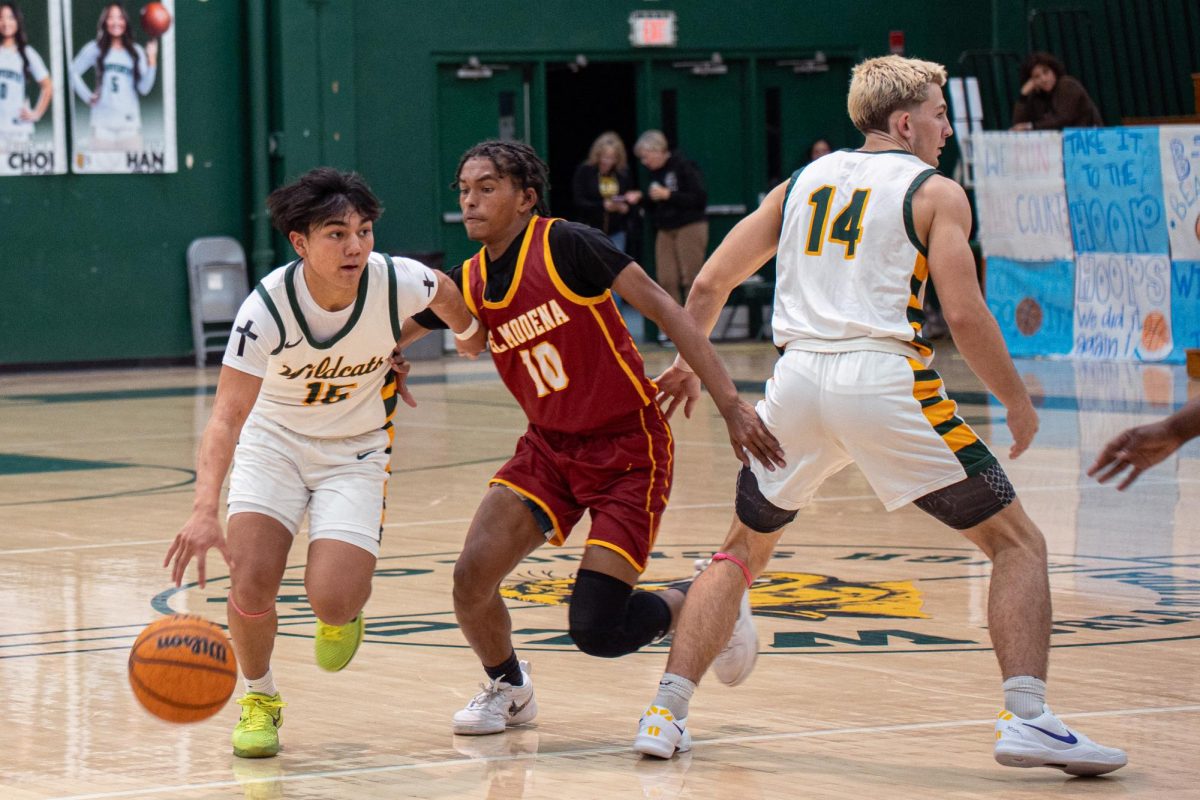 Tyson Tayag ('26) dribbles past an EL Modena defender. The do-everything point guard contributed 4 points, 5, rebounds, and 5 assists in the 63-54 victory.