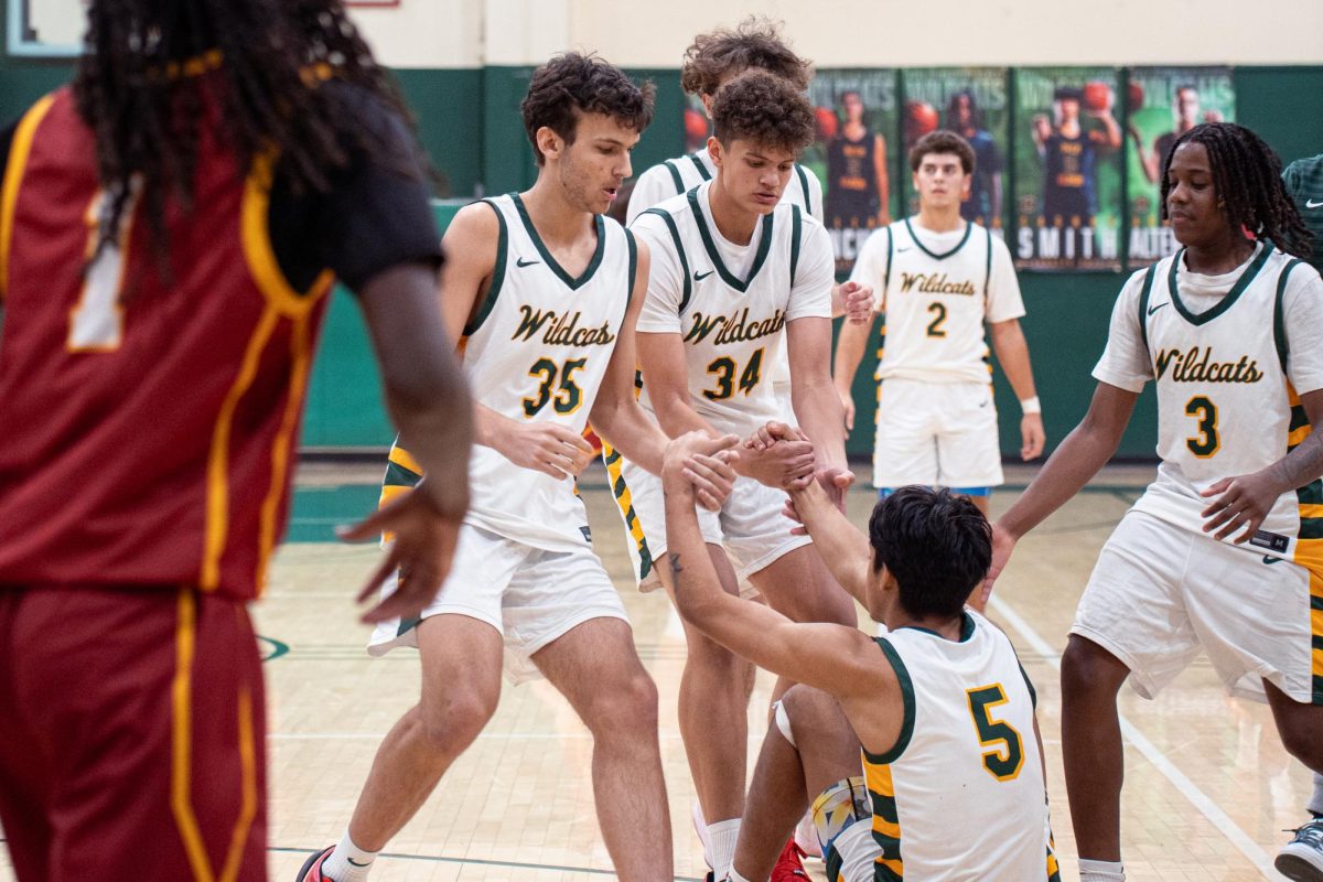 Tyson, Ford, and Isaiah Jackson ('25) help Smith off the floor. 