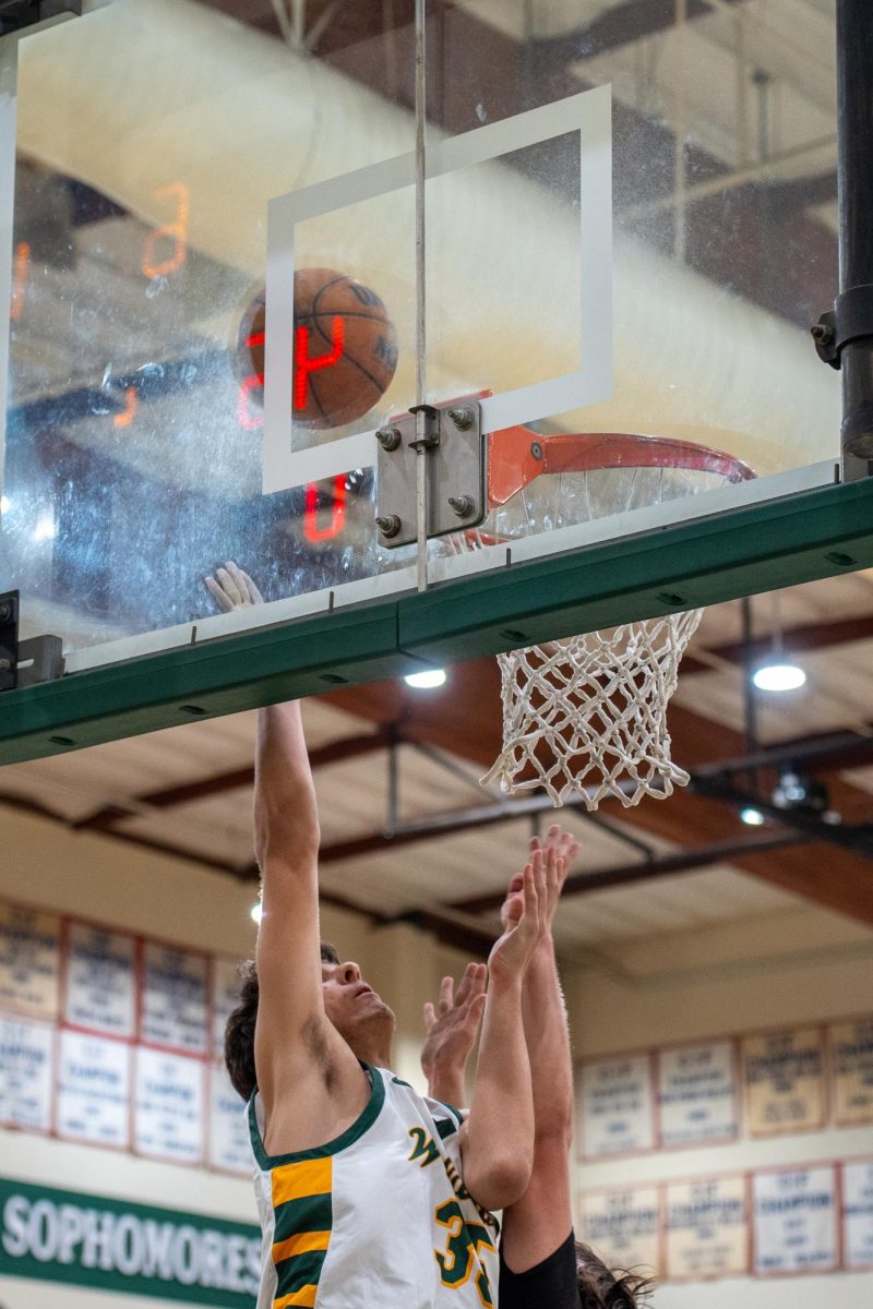 Steven Tyson ('25) banks in a lay-up over an El Modena defender. 