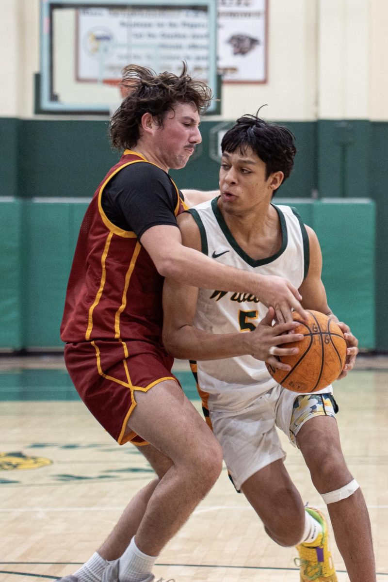 Cashus Smith ('25) powers into the lane. The veteran forward contributed 2 points, 4 rebounds, a steal and a block in the game. 