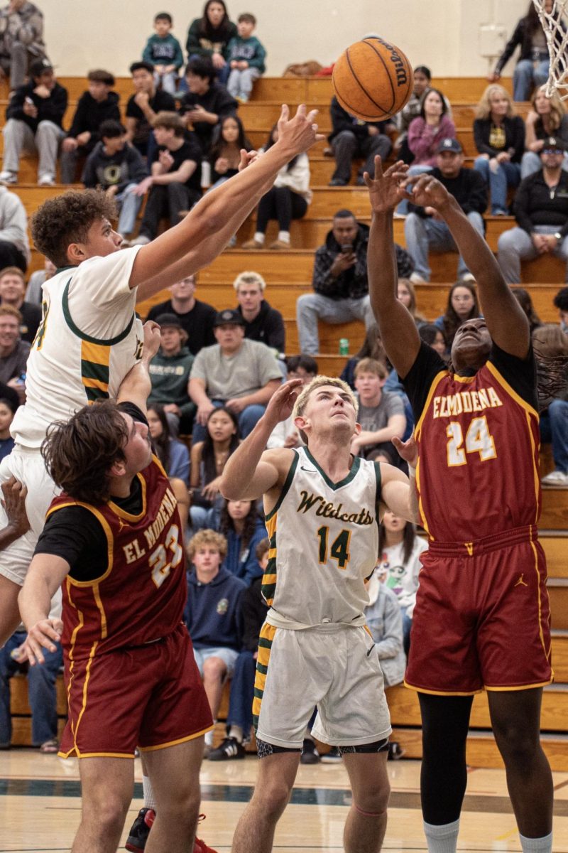 Nathaniel Ford ('27) rises for a rebound over an El Modena player. The sophomore center contributed 6 points, 4 rebounds, and 2 blocks in the win. 