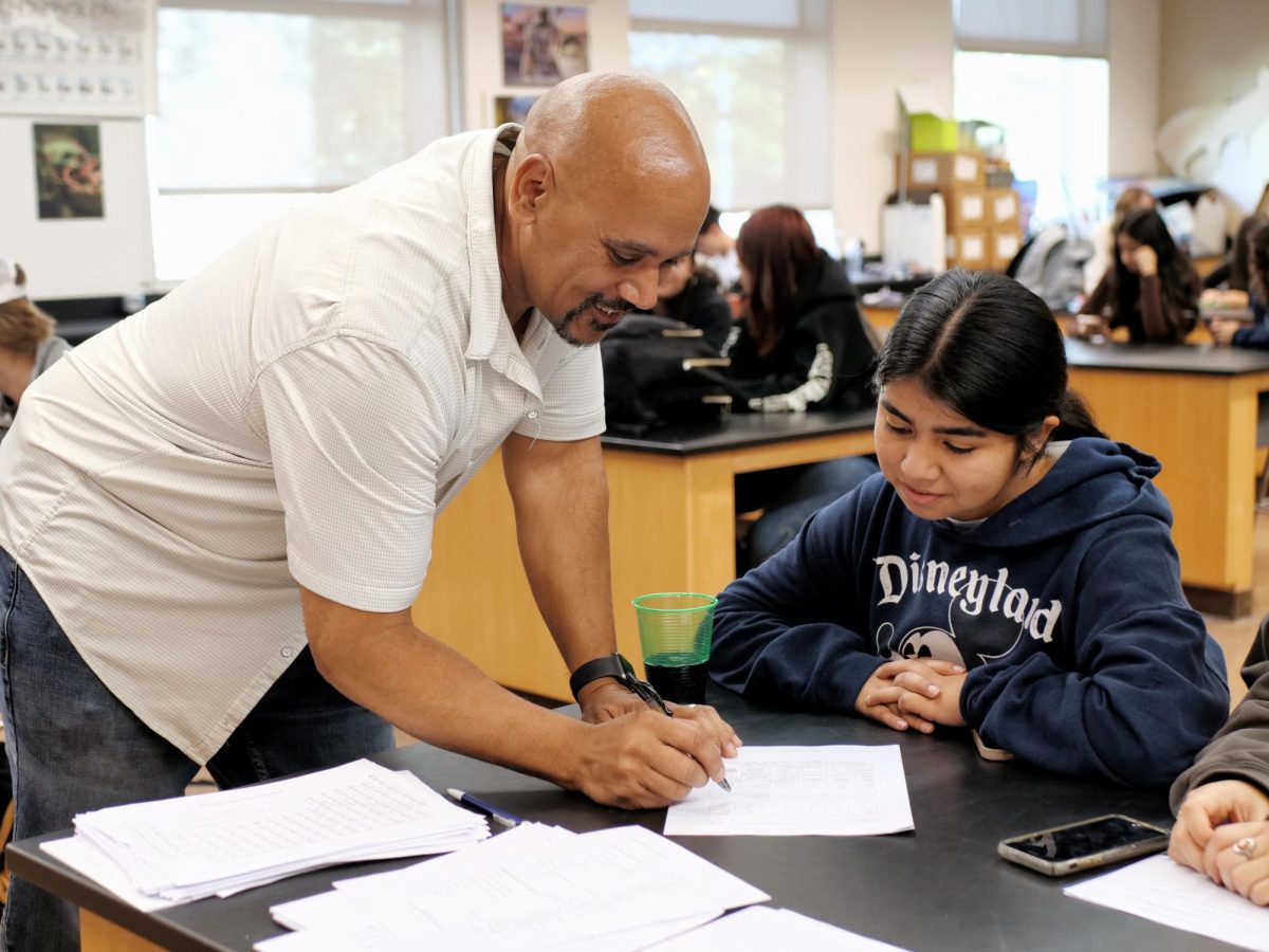 Chemistry teacher Wade Cormier helps his student, Kayle Alonzo ('27), with a work sheet. Cormier received the BOHS Teacher of the Year recognition on Dec. 13 for his "unwavering dedication, innovative teaching methods, and exceptional rapport with students and staff."