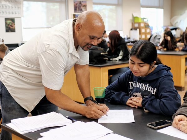 Chemistry teacher Wade Cormier helps his student, Kayle Alonzo ('27), with a work sheet. Cormier received the BOHS Teacher of the Year recognition on Dec. 13 for his "unwavering dedication, innovative teaching methods, and exceptional rapport with students and staff."