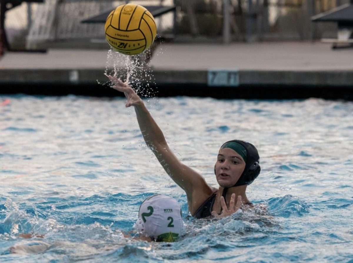 Zoey Szary ('28) makes a pass over a Cajon High School defender in the first round of CIF Feb. 7. 