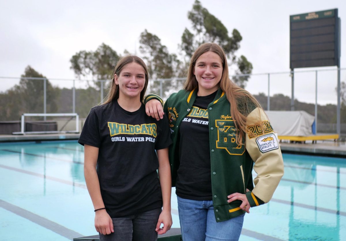 Varsity girls' water polo players Zoey ('28) and Rylee ('25) at the Wildcat pool deck. The sisters discovered the sport from their mother, Emily Flesher, who was a three-time national champion at the University of Redlands.  