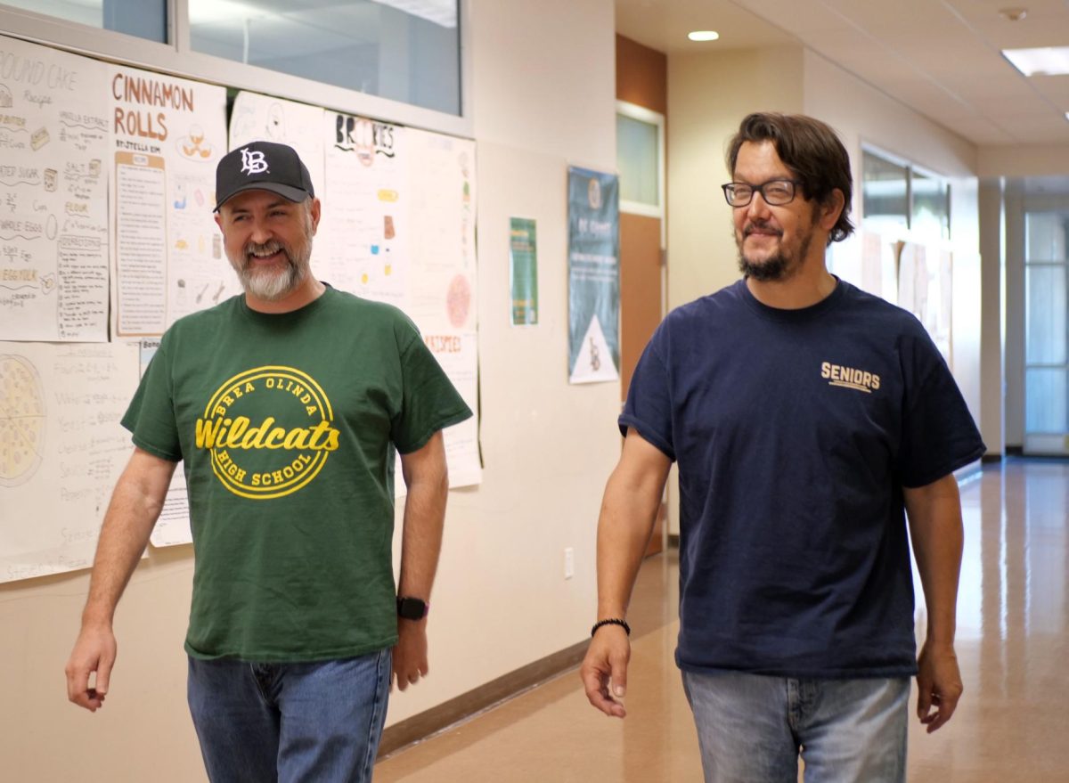 A common sight in M Building: English teachers Christopher Schaadt and Mitsuo Maeda walking, and laughing, side-by-side. The two have been colleagues and friends for 17 years. 