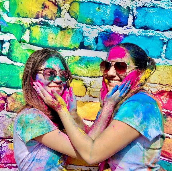 Befitting the Festival of Colors, Joy Baik (‘25) and Sahaana Mehta ('25) covered from head to toe in colored powder as part of a Holi party,  (Courtesy of Amit Mehta)