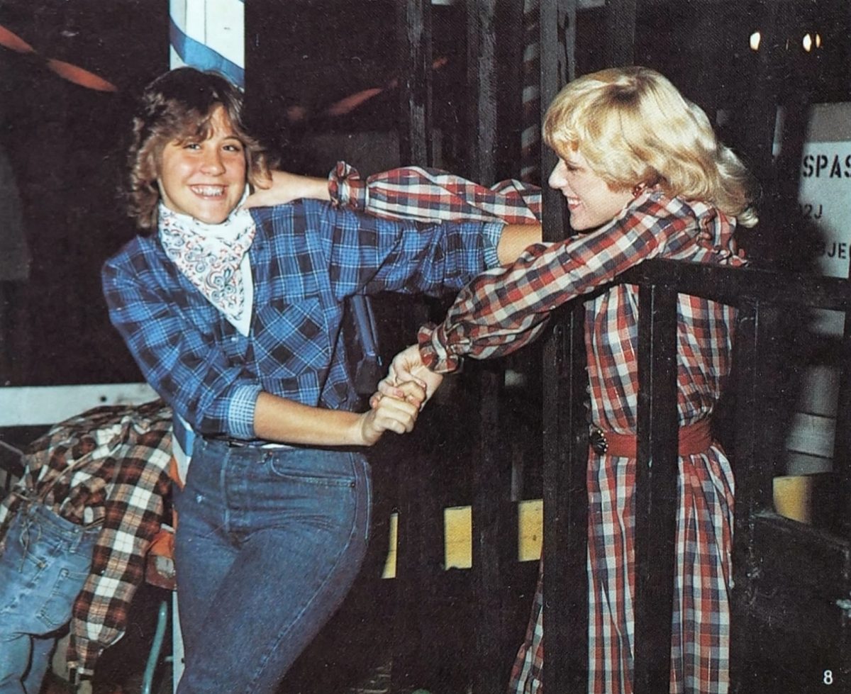 Angelique Bowles ('83) playfully grasps friend Cindy Bodnar ('83) at the 1982 Sadie Hawkins dance. The country-themed dance was inspired by a 1920s comic strip, and makes its (theme-less) return to the BOHS campus March 28. (Courtesy of the Gusher)