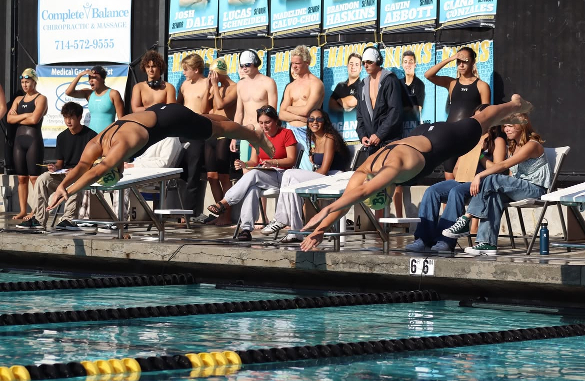 Christina Pai ('25), left, and Rylee Szary ('26), right, dive into the El Dorado High School pool for their 100-meter freestyle race May 2. Both Pai and Szary will compete in today's California Interscholastic Federation (CIF) Southern Section Qualifiers at Mt. San Antonio College in Walnut. (Courtesy of Noah Lovcik) 