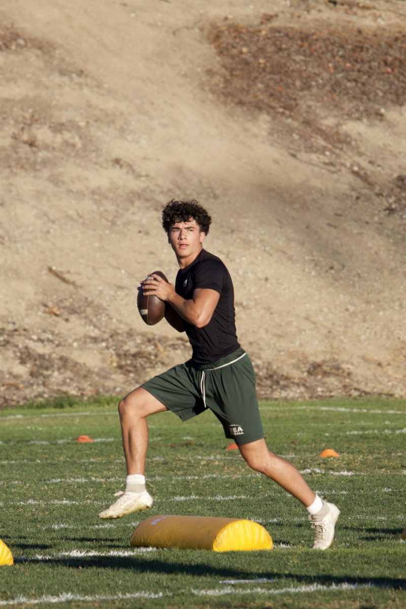 Quarterback Gavyn Nicholson (‘27) looks to throw the ball downfield in a football drill July 24.