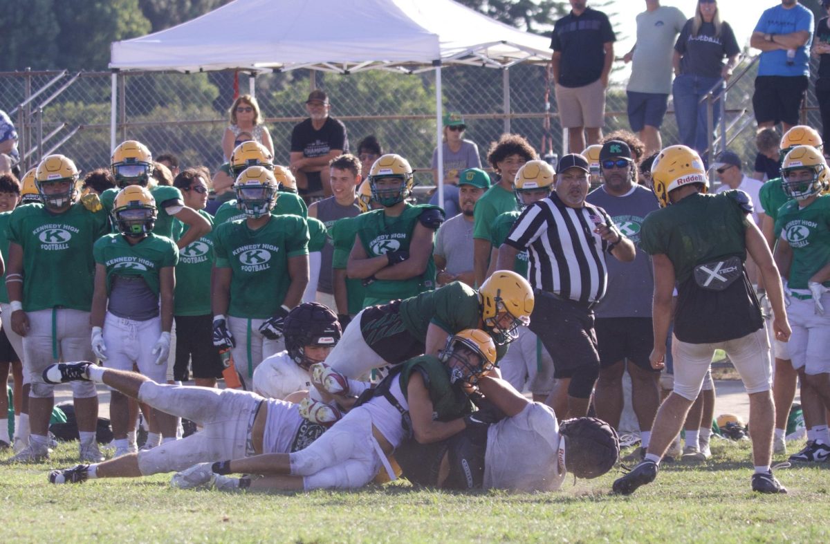 The Wildcats defense takes down a Troy ball carrier during a three-team scrimmage at Troy High School Aug. 15.