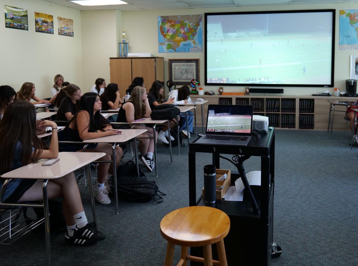 Girls' soccer retreats from the heat to watch game film in coach Paul Bottomley's classroom Aug. 21. Temperatures in the mid-90s and a UV Index of 9 and 10 forced cancellations of multiple sports' practices and games. 