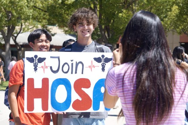 RJ Buenviaje ('26) and Ivan Haluska ('26) promote their club, Health Occupations Students of America (HOSA), in the BOHS quad Sept. 8.